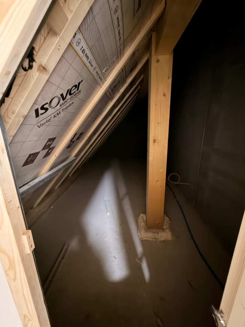 attic with wooden supports, plywood walls, some insulation material