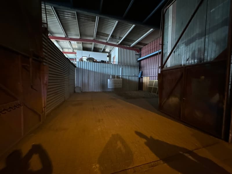 Industrial building, brick floors, metal roofing, large entrance doors