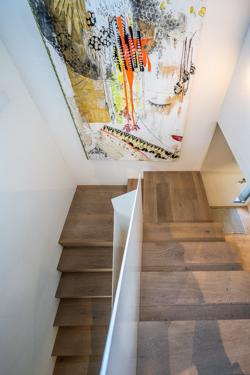 wooden stairs, white wall, abstract painting