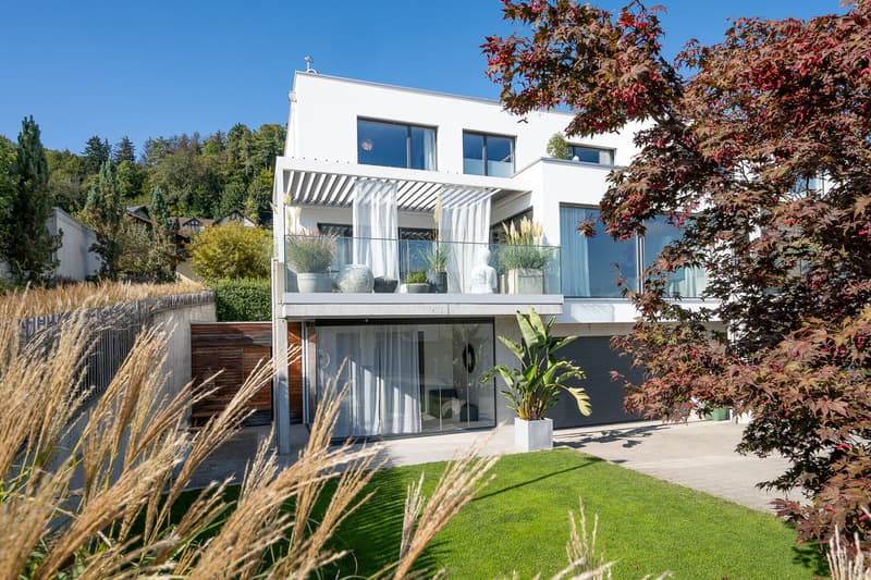 modern white house, 2 stories, large windows, balcony, garage, garden