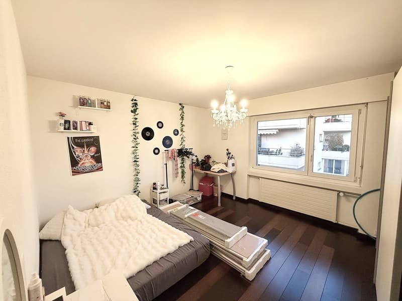 Bedroom with a double bed, bedside table, shelving, desk, window