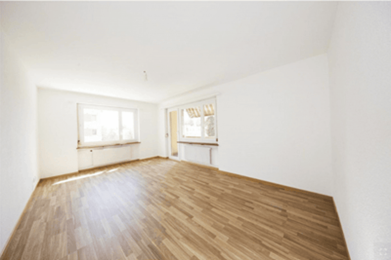 Empty room, hardwood floors, large windows, large doors, white walls