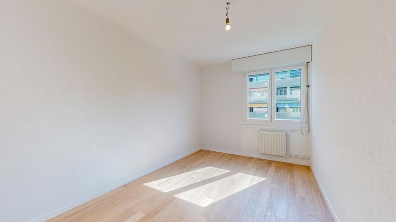 empty room, white walls, wooden floor, window, radiator