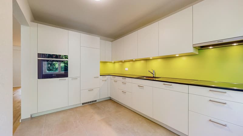 modern kitchen, white cabinets, yellow wall, stainless steel sink, oven, wooden floor