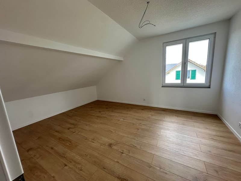 empty room, wooden floor, white walls, window, slanted ceiling
