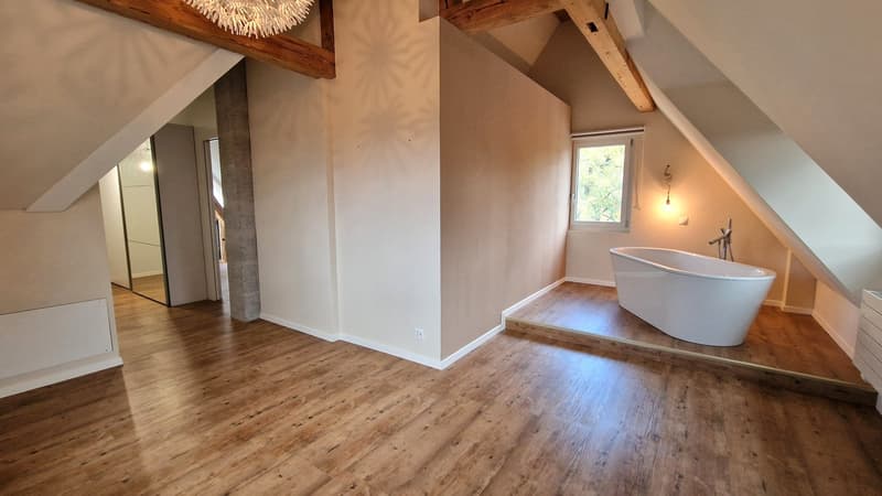 free standing bathtub, wooden floor, natural light
