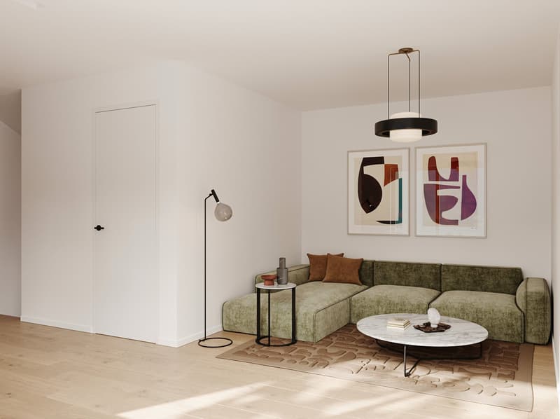 Spacious living room with white walls, hardwood floors, a large green sectional sofa, a round marble coffee table, and abstract artwork on the walls. The room also features a floor lamp and a modern pendant light fixture.