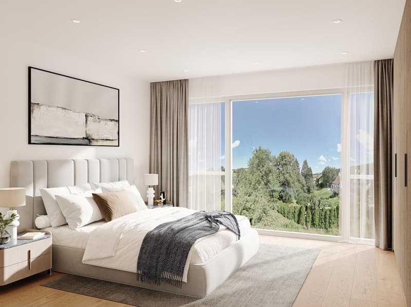 Spacious bedroom with large windows offering a scenic view of the surrounding trees and landscape. The room features a plush white bed with decorative pillows, a modern artwork on the wall, and neutral-toned curtains and decor.