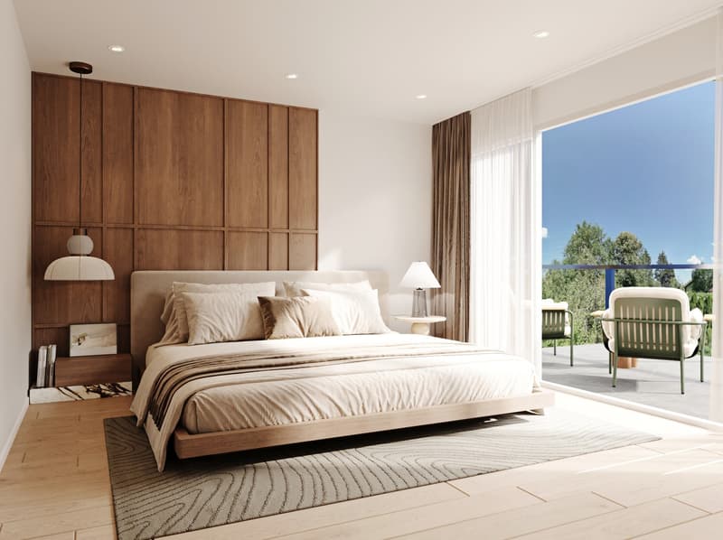 Spacious bedroom with a large bed, wooden paneled wall, and access to a balcony or terrace with outdoor furniture.