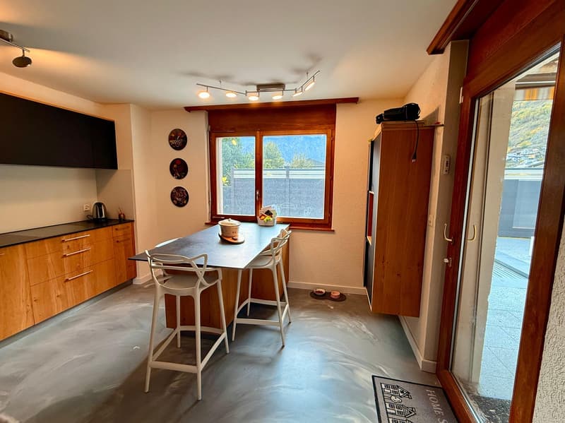 kitchen with breakfast bar, wooden cabinets, grey floor, windows, coffee machine, kettle
