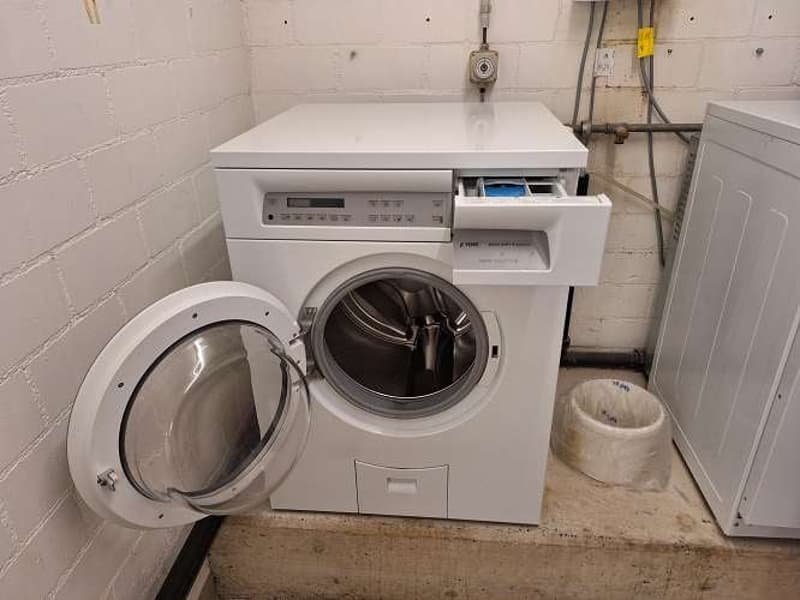 White washing machine and dryer in laundry room