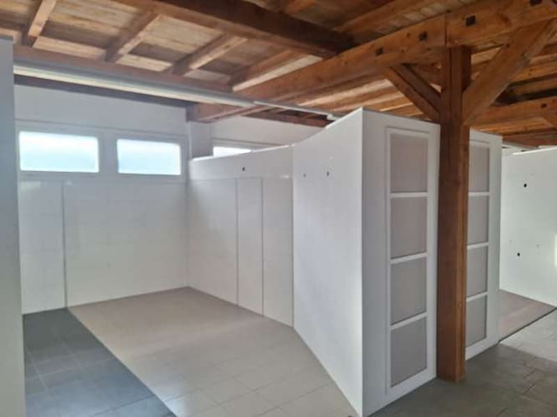 Room: open space, wooden ceiling, wooden floor, white walls, white tiled floor, white cabinets, two windows