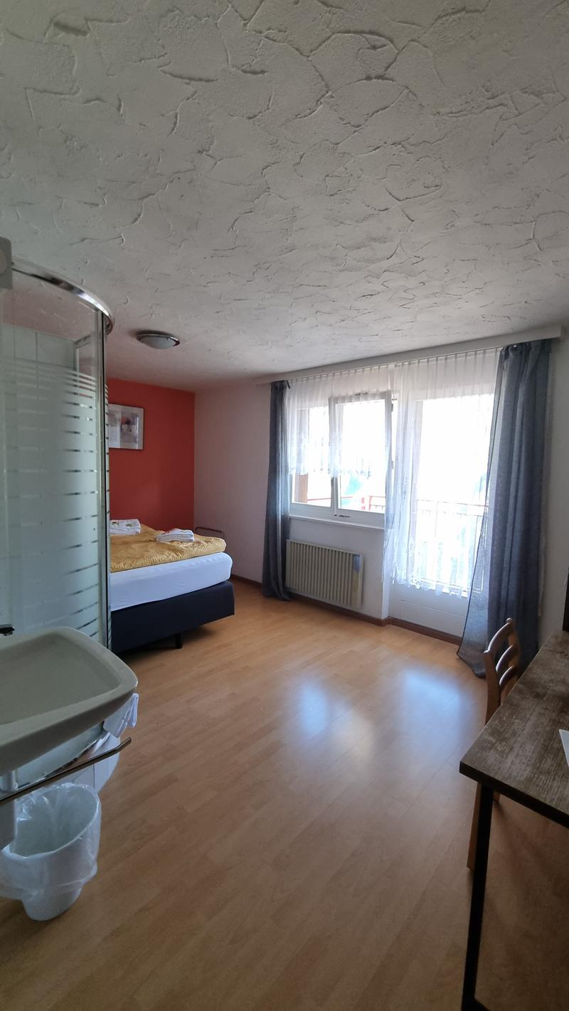 bed, radiator, window, shower, sink, chair, desk, trash can