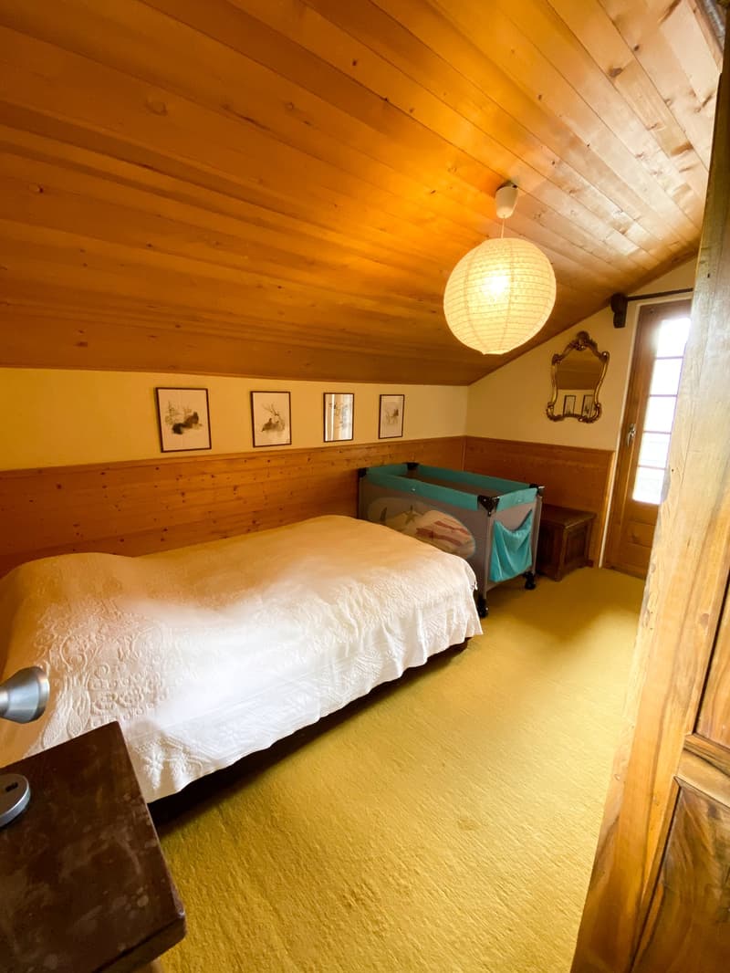 single bed, hanging lamp, nightstand, mirror, picture frames, wooden crib, wooden panelling, yellow floor