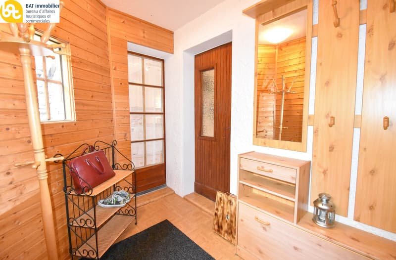 Wooden walls, large window, wooden furniture, storage cabinet, decorative rack