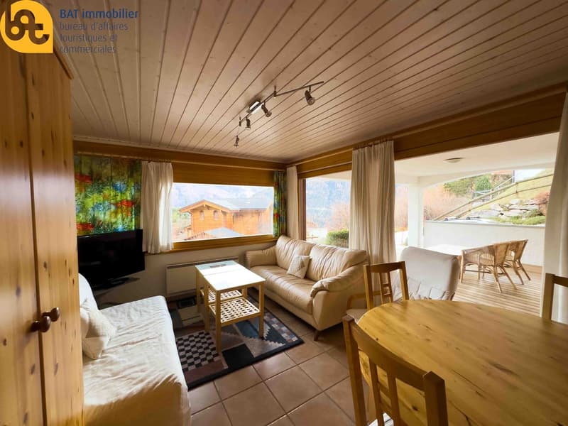 tiled floor, beige sofa, wooden table, carpet, TV, balcony, dining area