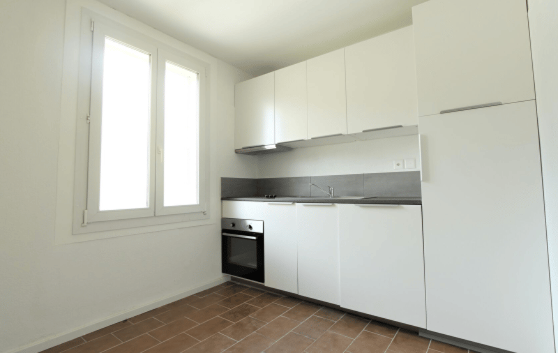 modern kitchen with white cabinets, tiled floors, oven, sink, dishwasher, window
