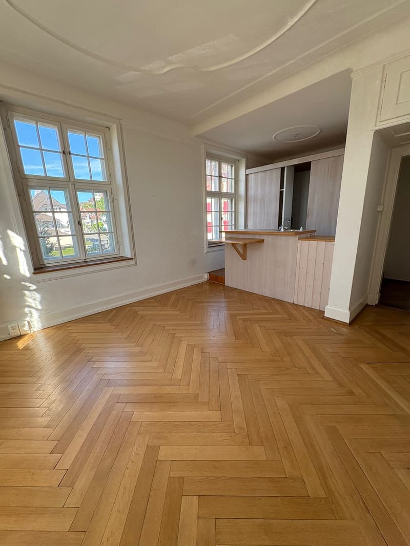 spacious room, wooden herringbone flooring, kitchen area, window seat, modern design