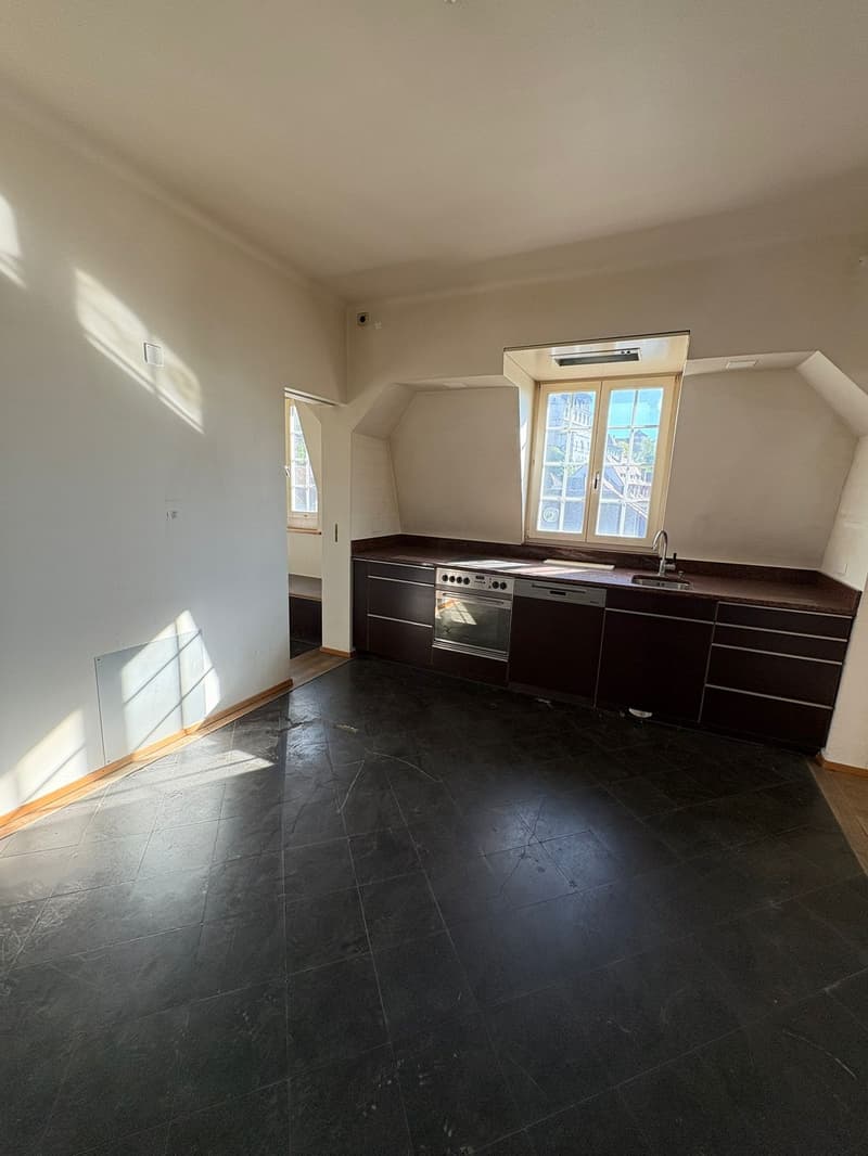 Empty kitchen with cabinets, sink, faucet, and dishwasher
