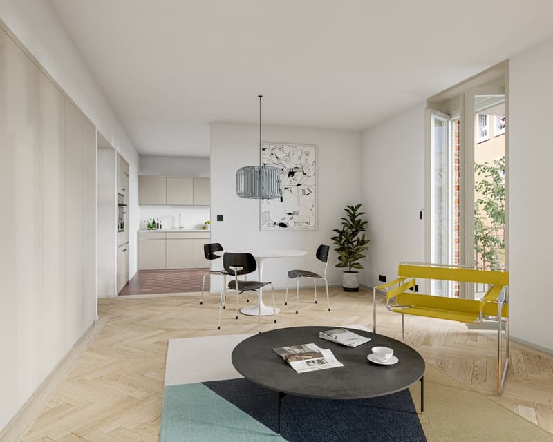 Bright and modern living room with hardwood floors, white walls, large windows, a round black coffee table, two black chairs, a yellow bench, and a kitchen visible in the background.