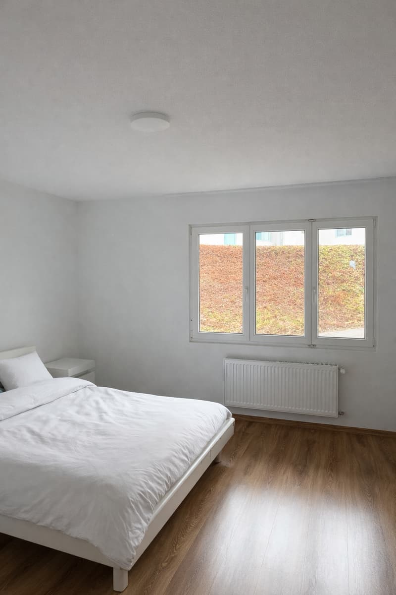 Bedroom with bed, nightstand, and window with view