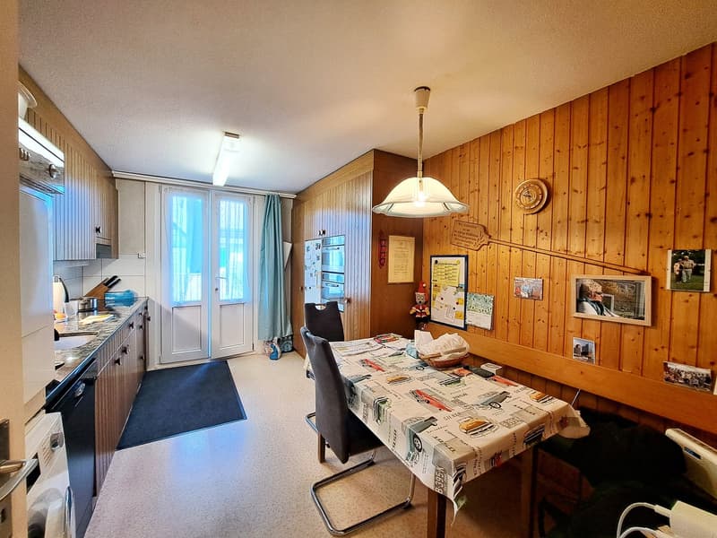 modern kitchen, dining table, sink, fridge, stove, wooden cabinets, wooden walls, lamps, tableware, decorative items
