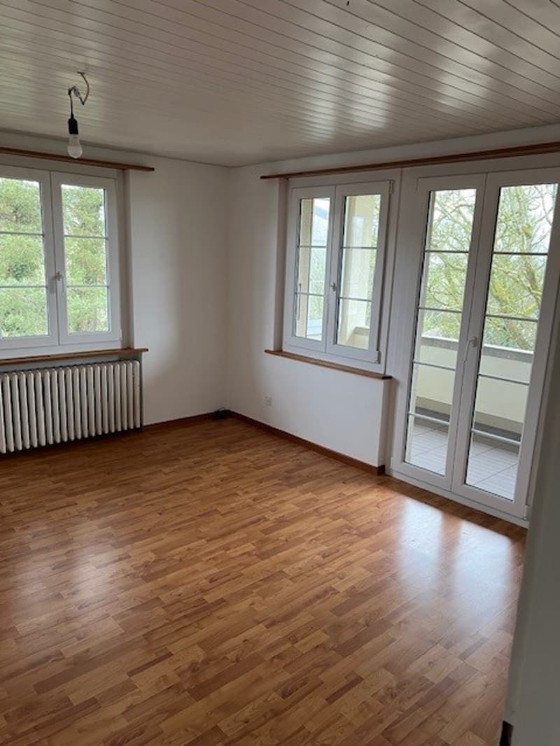 room, hardwood floors, white walls, large windows, balcony