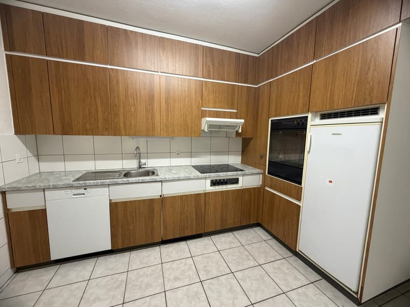 modern kitchen with wooden cabinets, granite countertop, stainless steel sink, gas stove, oven, dishwasher, refrigerator, and washing machine