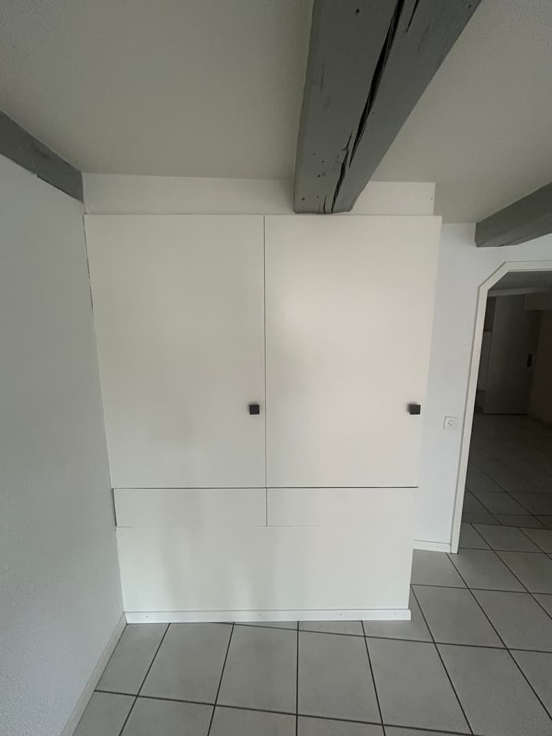 white cabinet, power outlet, tiled floor, empty room