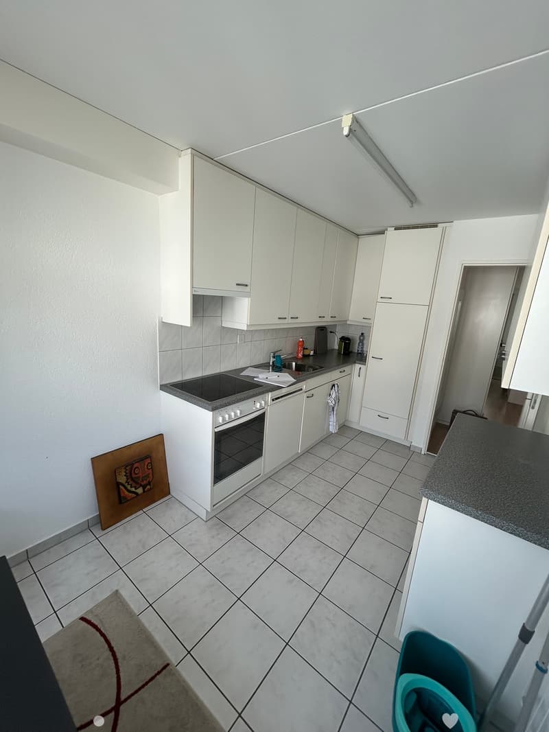 modern kitchen with white cabinets, tiled floor, gas stove, dishwasher, sink, countertop, white walls, ceiling light
