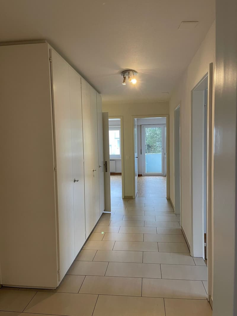 white tiled floor, white cabinets, lit ceiling, doors, balcony with plants