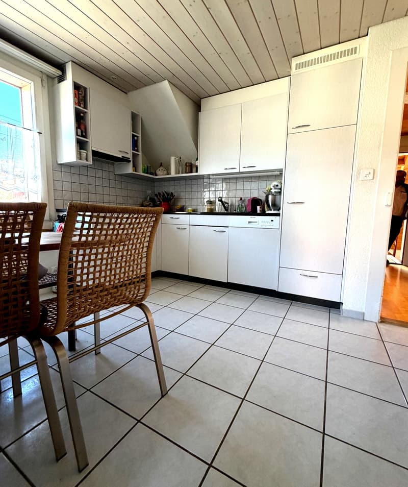 modern kitchen with white cabinets, tiled floor, sink, dishwasher, washing machine, and various kitchen appliances