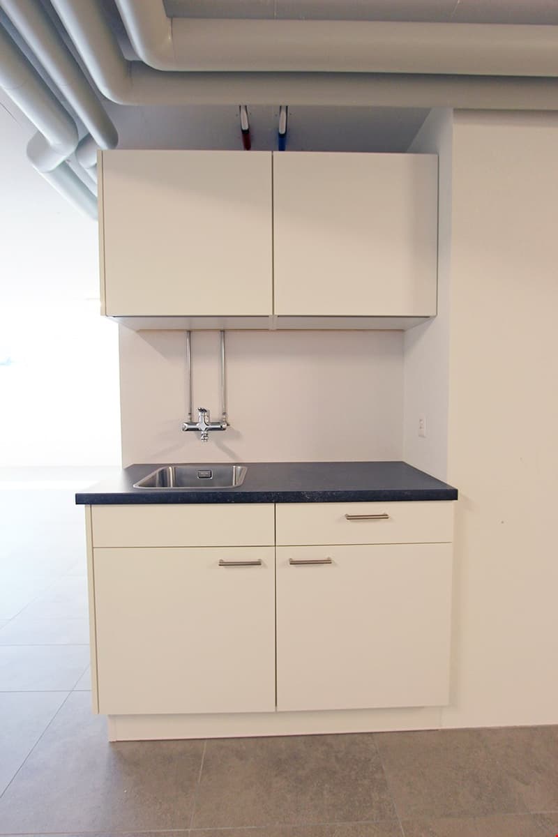 kitchen with white cabinets, granite countertop, stainless steel sink, modern faucet
