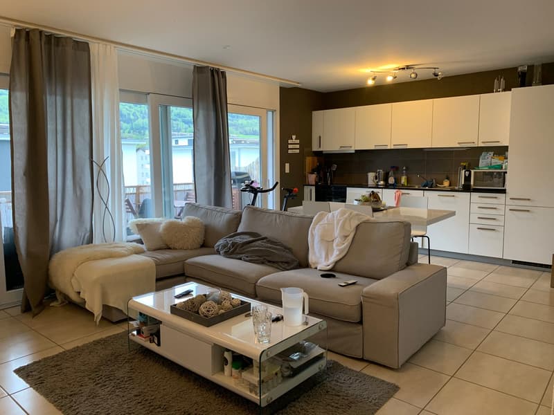 L-shaped sofa, coffee table, carpet, kitchen, balcony, large windows, view