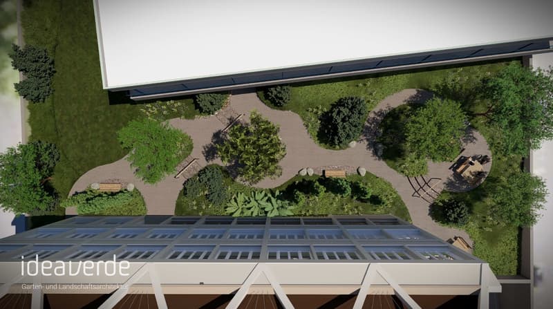 Aerial view of a garden with winding paths, benches, and a small table with chairs.