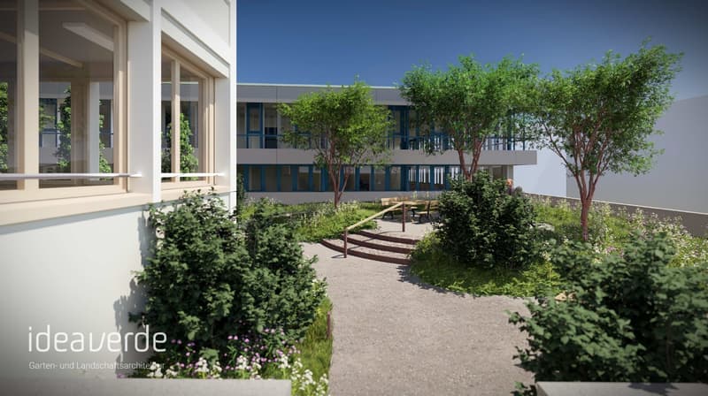 Garden with trees, shrubs, flowers, benches, and a pathway leading to a building with glass windows.