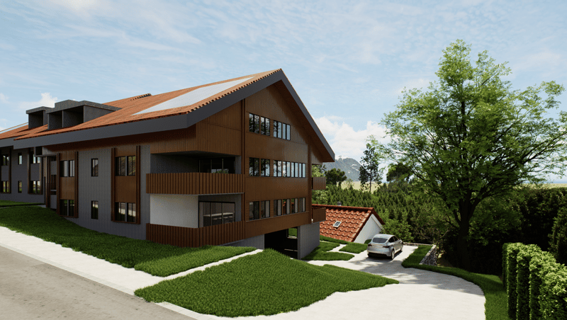 2-story modern wooden house with a slanted roof, large windows, and a garage. The house is surrounded by a well-manicured lawn and trees, providing a scenic natural setting.