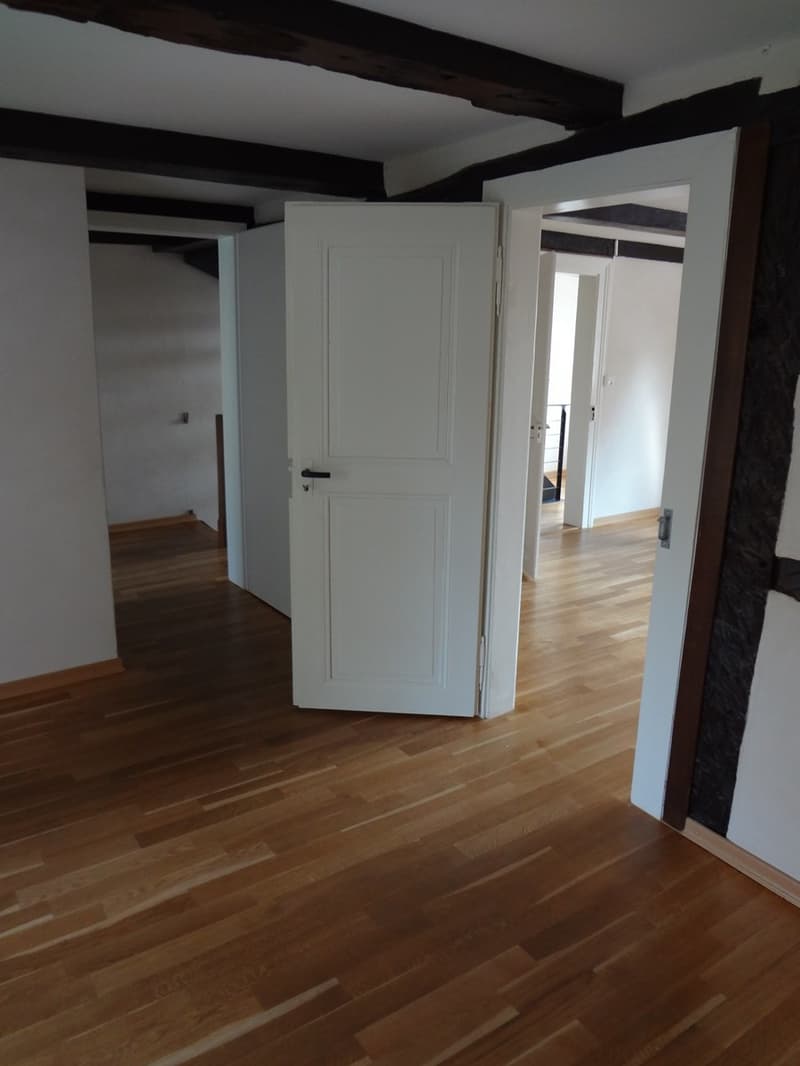 empty room, hardwood floor, white walls, open doors