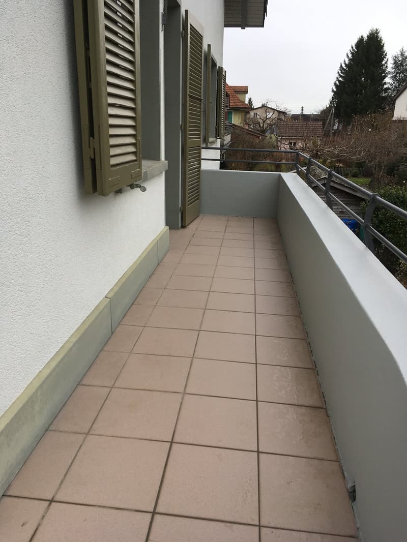 tiled floor, metal railing, green shutters, white wall
