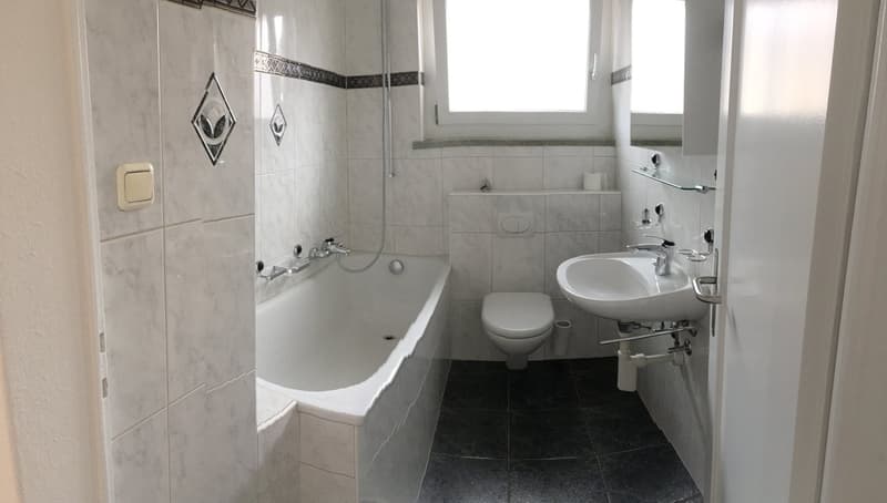 Bathtub, toilet, sink, shower, window, tiled walls, tiled floor