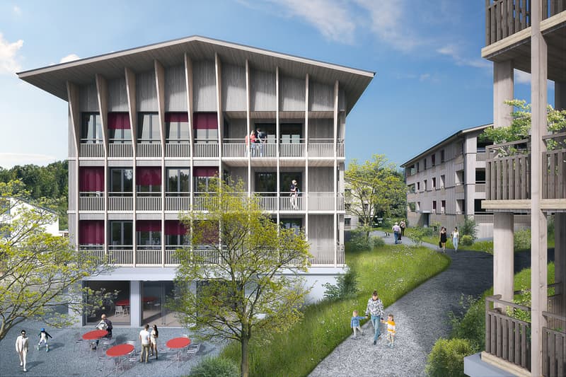 Modern apartment building with multiple balconies, large windows, and a central courtyard.