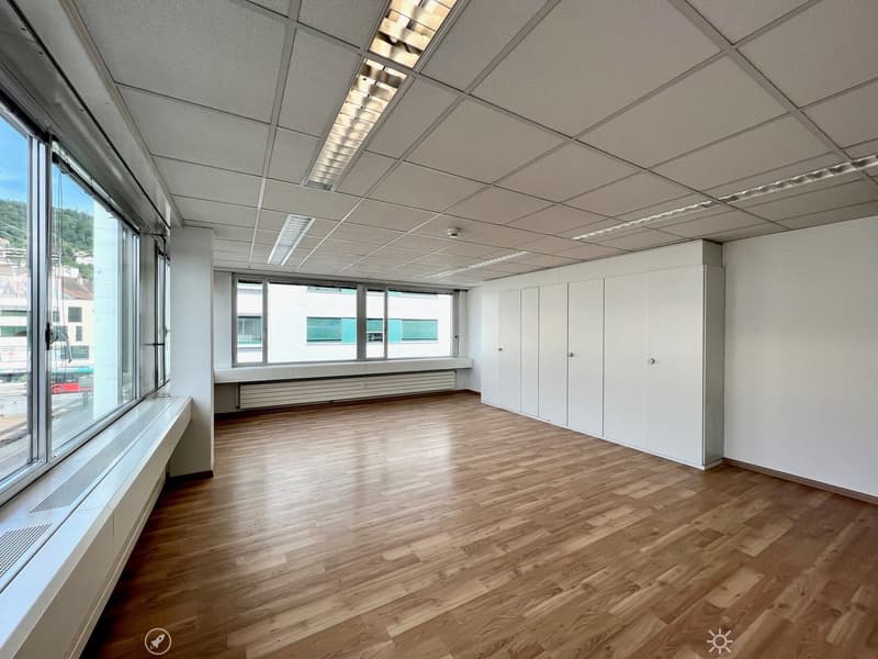 Empty room, large windows, white walls, white ceiling, wooden floor, built-in white cabinets