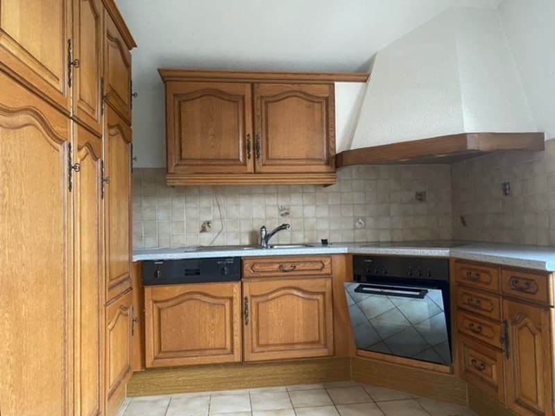 kitchen with wooden cabinets, tiled floor, sink, dishwasher, oven