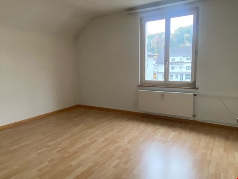 empty room, wooden floor, white walls, large window, radiator