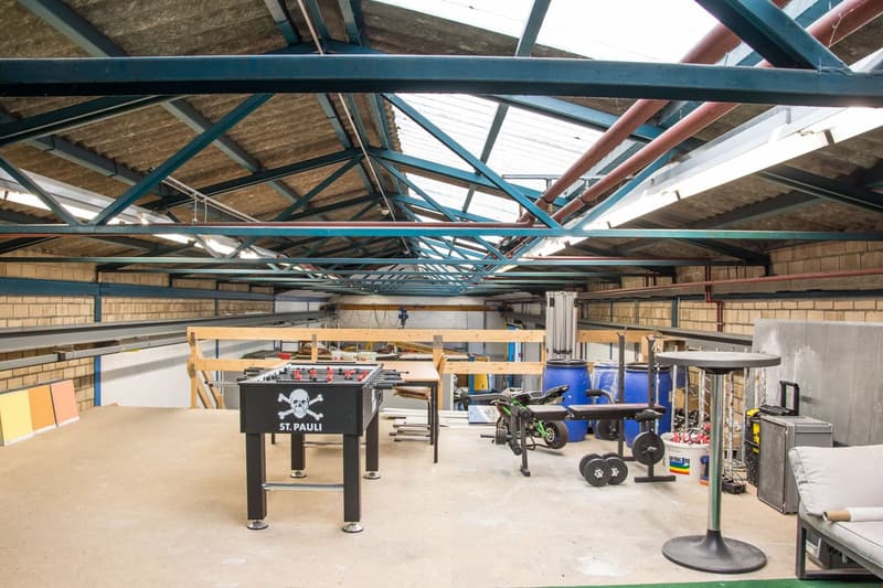 metal beams, brick walls, indoor foosball, gym equipment, blue barrels, wooden planks