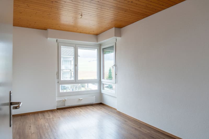 empty room, wooden floor, white walls, two windows, wooden ceiling