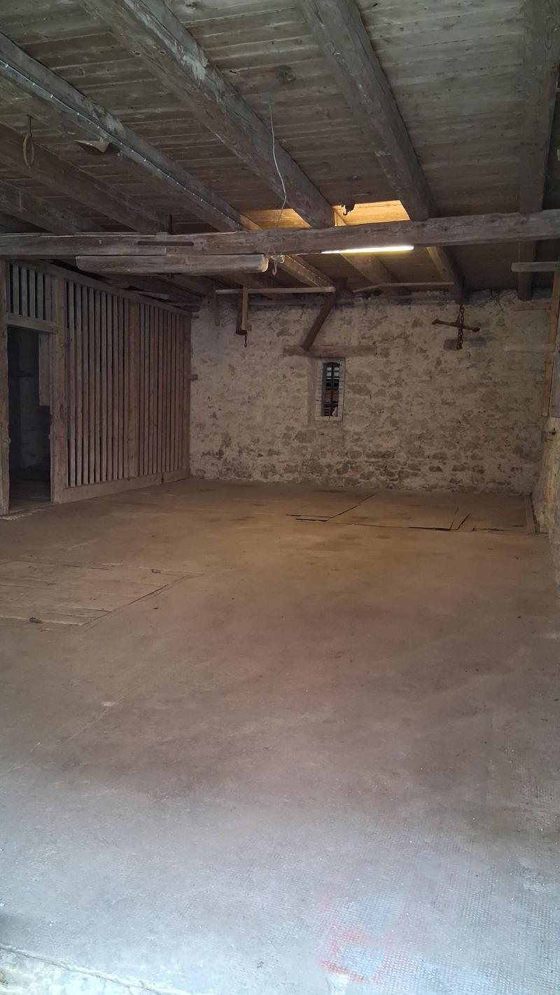 Empty room with wooden beams, concrete floor, large open space