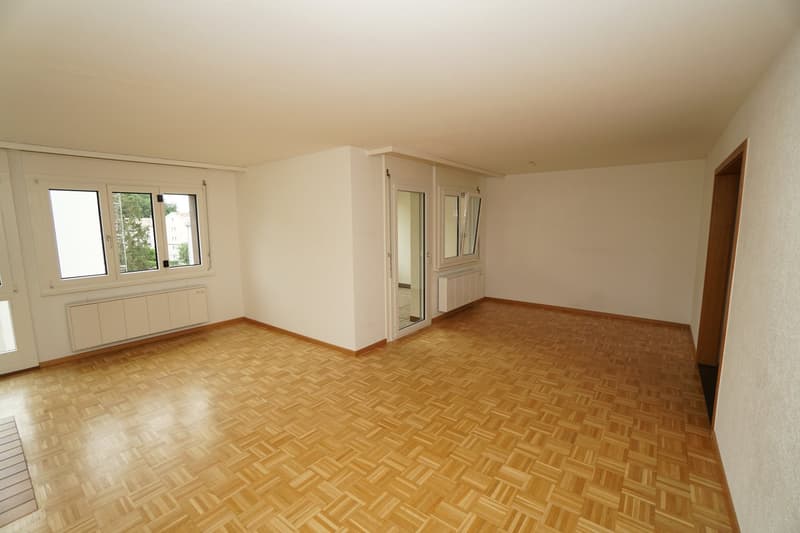 empty room, wooden parquet floor, white walls, large windows, sliding door, radiators