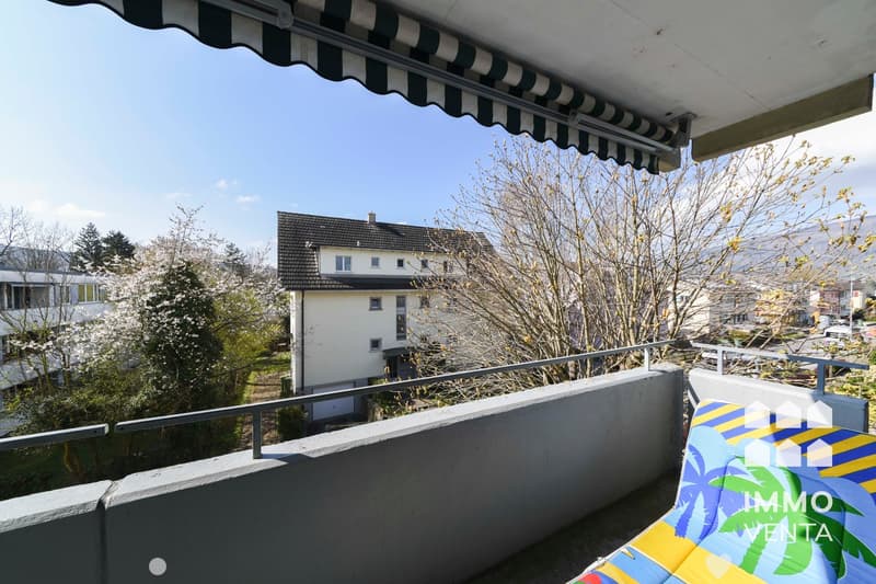 Balcony with railings, awning, and a view of the house and surroundings