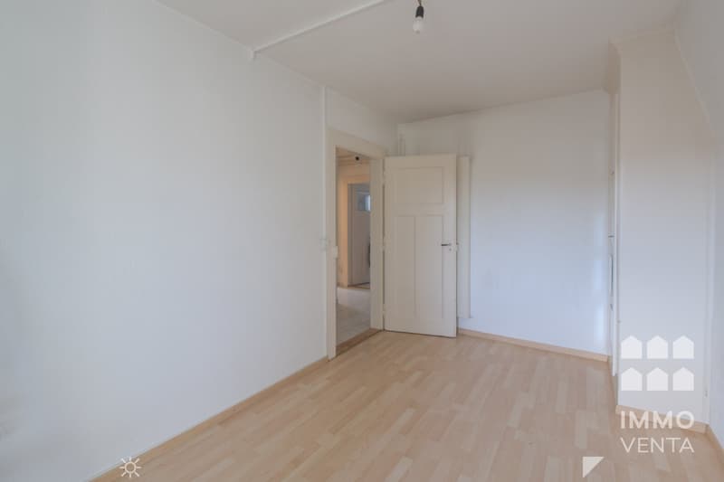 empty room, white walls, wooden floor, open door, light fixture